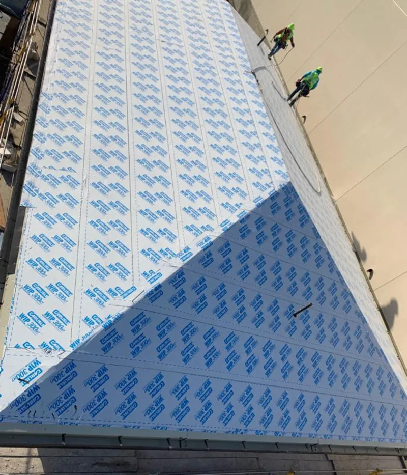 Professional roofers installing underlayment on a metal roof in San Lorenzo